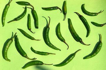 Green Chilli spice vegetables on green background. Pepper for recipe delicious taste. Capsicum vegetables. 