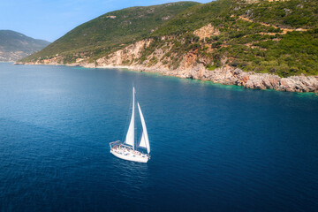 Aerial view of beautiful yacht at sunset. Boat on the sea in summer. Lefkada island, Greece. Top...