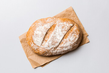 Freshly baked delicious french bread with napkin on rustic table top view. Healthy white bread loaf