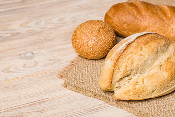 Homemade natural breads. Different kinds of fresh bread as background, perspective view with copy space
