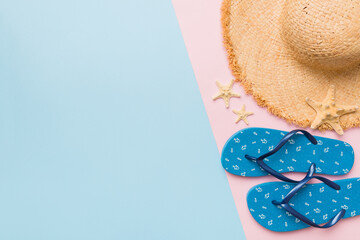 Summer vacation concept flat lay. straw hat beach accessories and flip flop top view. Space for...