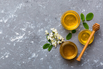 honey jar with acacia flowers and leaves. fresh honey top view flat lay