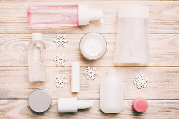 Makeup products and Christmas decorations on color background. Top view New year Beauty concept
