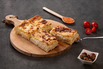 Water pastry on the plate. Composition of water pastry, tomato, hot pepper and olives on old wooden table.