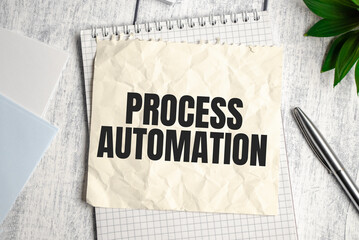 Text PROCESS AUTOMATION on Office desk on wooden background