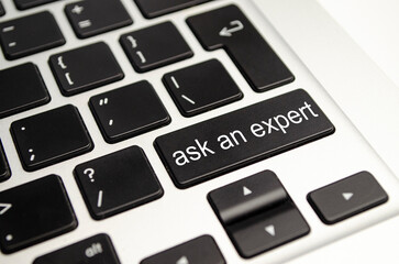 Close up button with the words ask an Expert, on a black keyboard. Creative background, copy space.