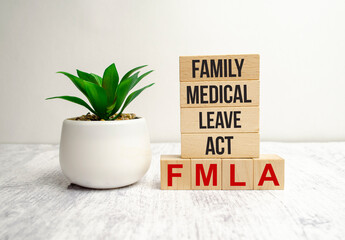 FMLA family medical leave act symbol. Concept words FMLA family medical leave act on wooden blocks