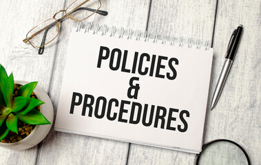 policies and procedure text on notepad with glasses, pen and calculator - obrazy, fototapety, plakaty