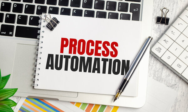 PROCESS AUTOMATION text on notepad and laptop, calculator and pen