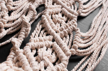 threads in the style of macrame on a black background