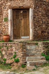 Fototapeta na wymiar Old wood door in a stone house.
