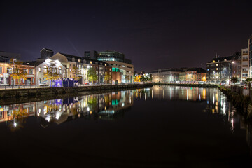 Fototapeta na wymiar Cork City, Ireland - Oct 12th, 2021: Beautiful view of River Lee reflections, colors and lights in the evening