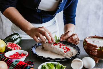 mexican woman hands preparing and cooking chiles en nogada recipe with Poblano chili and ingredients, traditional dish in Puebla Mexico