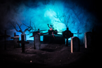 Scary view of zombies at cemetery dead tree, moon, church and spooky cloudy sky with fog, Horror...