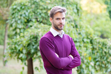 young handsome man in casual style crossed hands outside