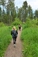 Youing female hikers on Lion Mountain Trail near Whitefish, Montana on sunny summer morning.