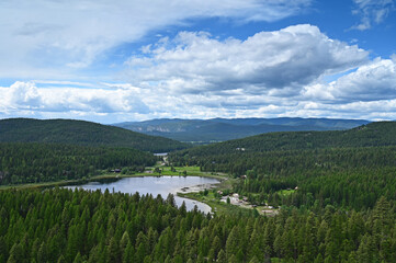 Skyles Lake from Lion Mountain Trail near Whitefish, Montana under sunny summer cloudscape..