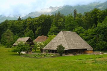 Fototapeta na wymiar A picture of old traditional Suisse farmhouse and cheese storehouse insight at the forest.