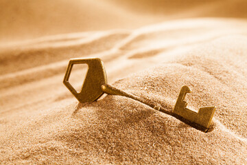 lost key found in sand. opportunity concept.