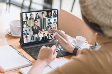 Business woman working on note book computor with diverse colleagues in online briefing with laptop at home. VDO conference call with business partner group. 