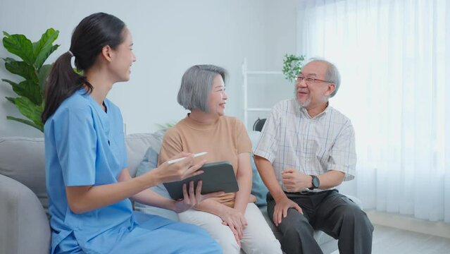 Asian caregiver nurse examine senior woman patient and husband at home