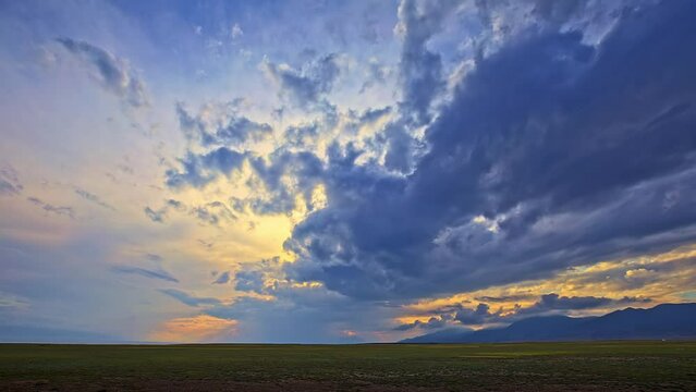 Beautiful mountain and colorful cloud nature scenery in Xinjiang at sunset, China.