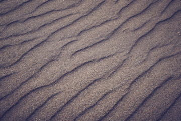 Fototapeta na wymiar Sand waves and texture of desert as background. Lack of water, hot dry soil. Lifeless landscape without vegetation