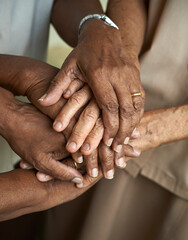 Close up of elderly people putting their hands together. Friends with stack of hands showing supporting each other