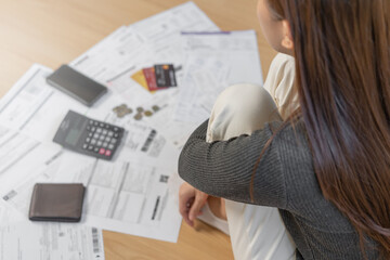 Financial owe asian woman, female sitting on floor home, stressed and confused by calculate expense...