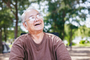 Elderly retired healthy lifestyle. Asian retirement senior relax on chair on a summer day in park