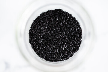 pantry jar with black rice shot from top down perspective as close-up, simple staple ingredients