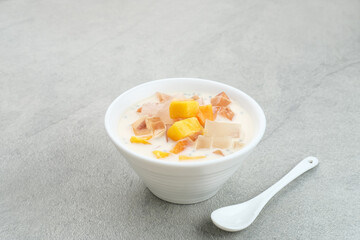 Mango Cheese Milk, a dessert made from jelly, nata de coco, basil seed, sweet mango, cream cheese and milk.
