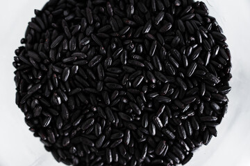 pantry jar with black rice shot from top down perspective as close-up, simple staple ingredients