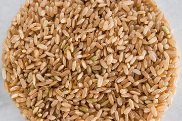 pantry jar with brown rice shot from top down perspective as close-up, simple staple ingredients