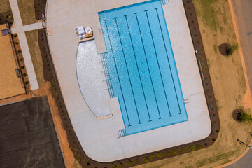 A swimming pool is with water used for swimming other water activities in near apartment