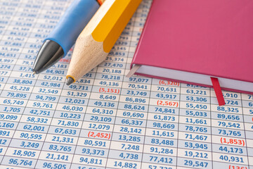 Giant Pencil and Pen with Calculator on Spreadsheet