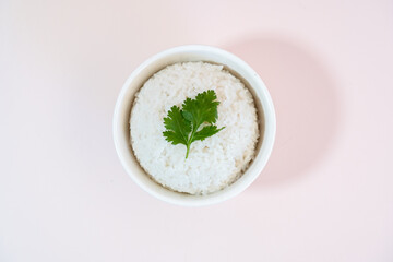 A studio shot of a bowl of rice on a plain background.