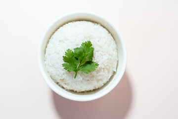 A studio shot of a bowl of rice on a plain background.