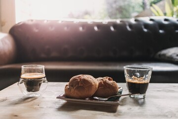 Morning break espresso coffee with desserts in calm living room.