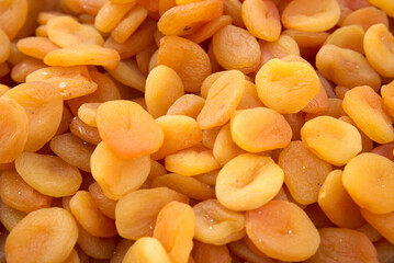 Dried fruits and berries on gray background top view. Lemons, oranges, bananas, raisins, cranberries, kiwi, cherries, ginger, plums, strawberries, dried apricots, tangerines, dates, pineapples, figs.
