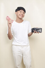 Asian man smiling to the camera while taking paper money from his wallet