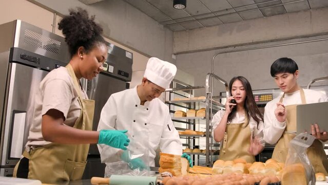 A chef's team staff who make bread dough and pastry foods are busy with homemade baking jobs while cooking orders online, packing, and delivering on bakery shop business, small business entrepreneur.