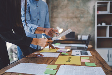 Business people are analyzing data graphs to plan business meetings with colleagues to propose collaboration strategies.