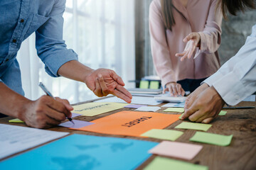 Business people are analyzing data graphs to plan business meetings with colleagues to propose collaboration strategies.
