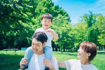 公園で肩車しながら遊ぶ親子