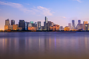 Panoramic skyline and modern commercial buildings with river in Hangzhou, China.