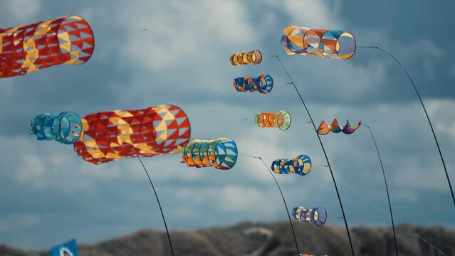 A close-up shot of parafoil kites floating in the air at the Romo kite festival. Pan follow.