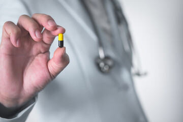 Fototapeta premium Doctor hand holding pill, medical treatment concept.