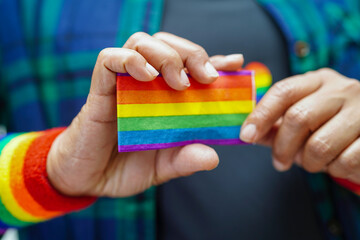 Asian woman with rainbow flag, LGBT symbol rights and gender equality, LGBT Pride Month in June.