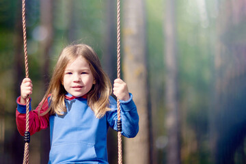 Little girl swinging close up portrait
